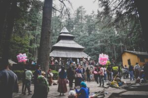 Historic Hidimba Devi Temple in Manali, surrounded by tall deodar trees, showcasing its unique wooden architecture and spiritual significance.