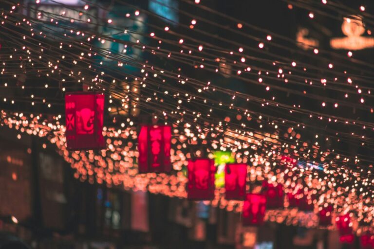 A festive Diwali home decorated with colorful lanterns, strings of fairy lights, and glowing diyas adorning the walls and windows.