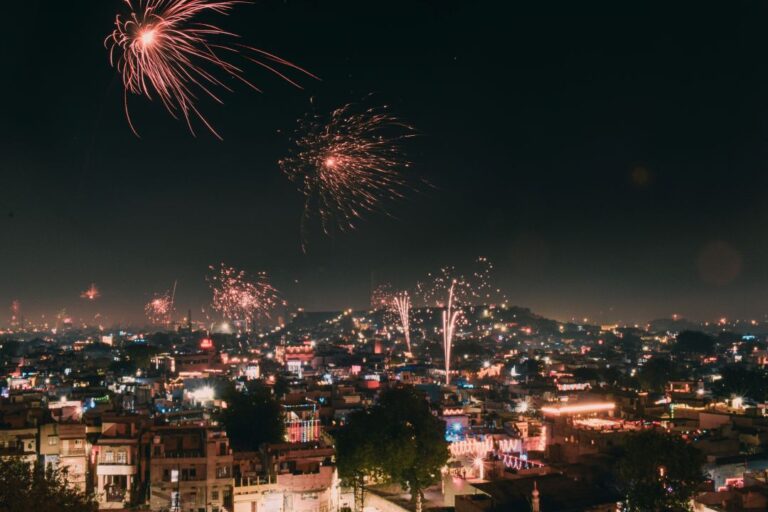 A breathtaking display of Diwali fireworks over a city skyline, symbolizing the triumph of light over darkness.