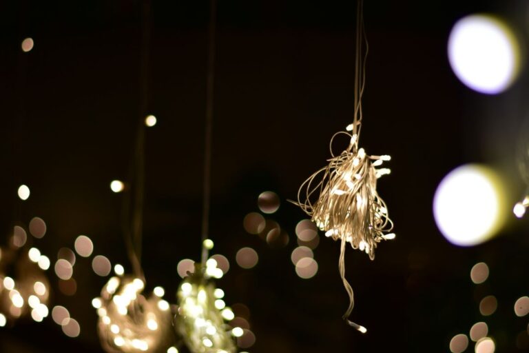 A beautiful display of sparkling Diwali lights hanging from the ceiling, casting a warm and festive glow across the room